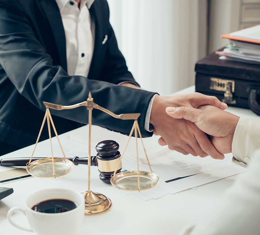 content-module-image-2-new Attorneys discussing with client for a contract agreement